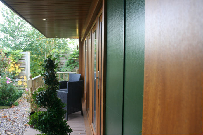 Garden office with juniper green walls and oak windows and pillars